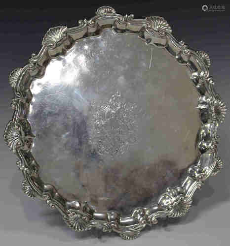 A George II silver circular card salver, engraved with an armorial within a raised 'C' scroll and