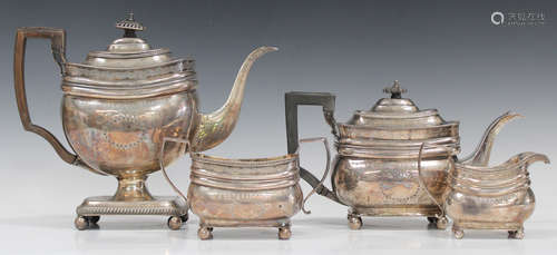 A George III silver four-piece tea set of cushion form, each engraved with scrolling and foliate