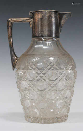 An Edwardian silver mounted cut glass claret jug with angular handle and hinged lid, Birmingham 1903