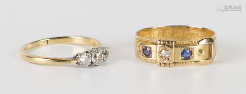 A gold and diamond three stone ring, claw set with a row of cushion shaped diamonds with the