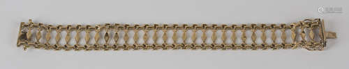 A 9ct gold bracelet in a pierced lozenge shaped and floral motif link design, on a snap clasp,