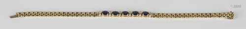 A gold, sapphire and diamond bracelet, mounted with a row five oval cut sapphires alternating with