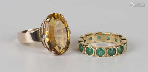 A gold and emerald full eternity ring, mounted with circular cut emeralds, ring size approx K1/2,