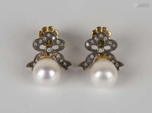 A pair of cultured pearl and diamond pendant earrings, each cultured pearl drop with a diamond set