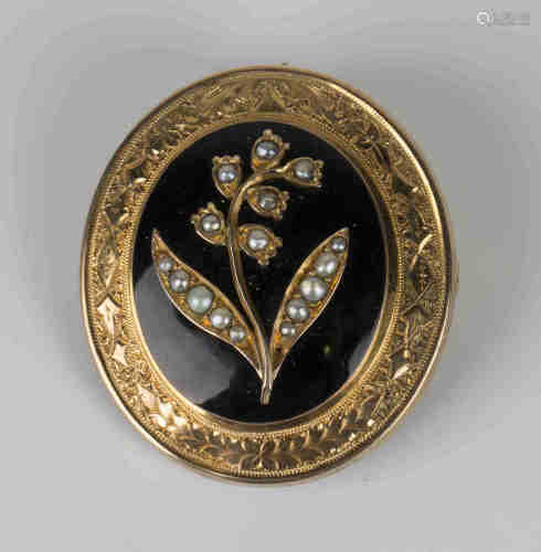 A Victorian gold, seed pearl set and black enamelled oval mourning brooch, the front mounted with