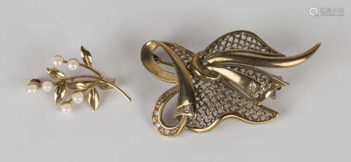 A 9ct gold and diamond brooch, pierced in a linenfold abstract design, mounted with circular cut