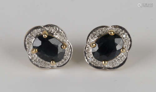 A pair of 9ct gold, sapphire and diamond shaped oval earstuds, each claw set with an oval cut