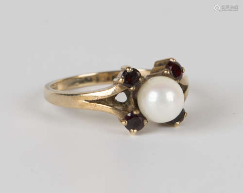 A 9ct gold, cultured pearl and garnet ring, mounted with four circular cut garnets, centred with a