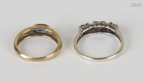 A 9ct gold, sapphire and diamond three stone ring, mounted with the oval cut sapphire between two