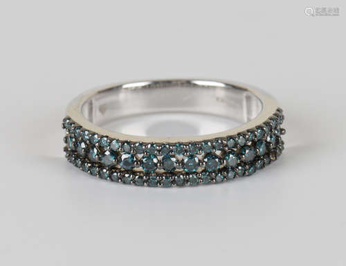 A 9ct white gold and treated blue diamond half-hoop eternity ring, mounted with a row of principal