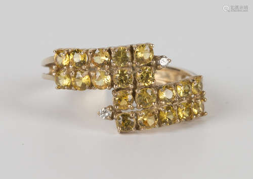 A 9ct gold, yellow sapphire and diamond ring, mounted with four rows of circular cut yellow