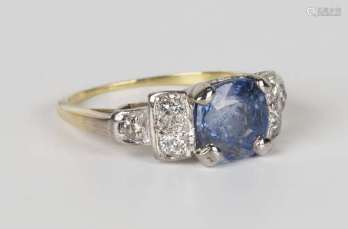 A gold, Ceylon sapphire and diamond ring, claw set with a cushion cut Ceylon sapphire between