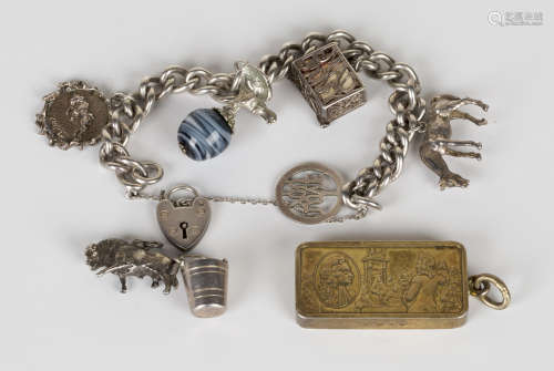 A silver curblink charm bracelet, fitted with five pendants and charms, with a heart shaped