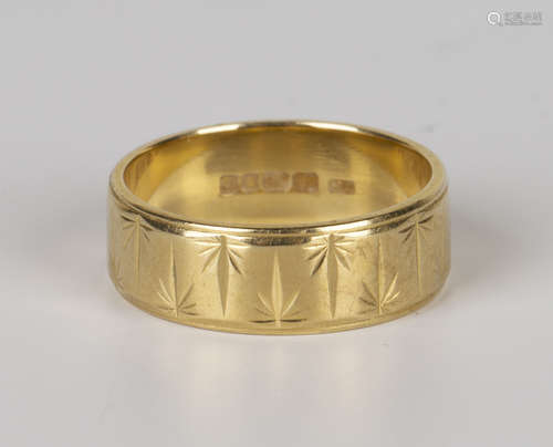 An 18ct gold wide band decorated wedding ring, London 1972, ring size approx L.Buyer’s Premium 29.4%