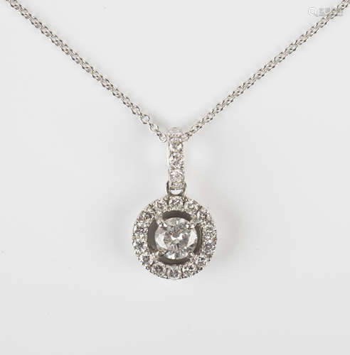 A white gold and diamond pendant, claw set with the principal circular cut diamond within an open