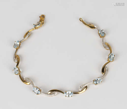 A 9ct gold, blue topaz and diamond bracelet in a serpentine link design, claw set with eight oval