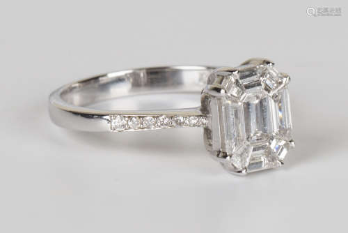 A white gold and diamond cluster ring, mounted with variously cut diamonds in a canted corner