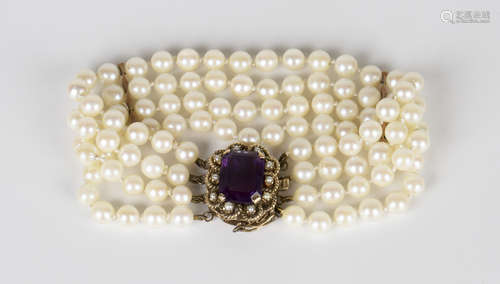 A four row bracelet of uniform cultured pearls on a gold, amethyst and seed pearl set shaped oval