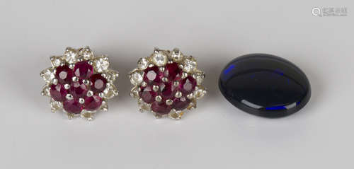 A pair of gold, ruby and diamond cluster earstuds, each claw set with seven circular cut rubies