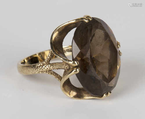 A 9ct gold ring, claw set with an oval cut smoky quartz, ring size approx O1/2, with a box.Buyer’s