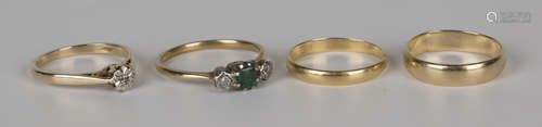 A gold, emerald and diamond three stone ring, a 9ct gold and diamond single stone ring, an 18ct gold