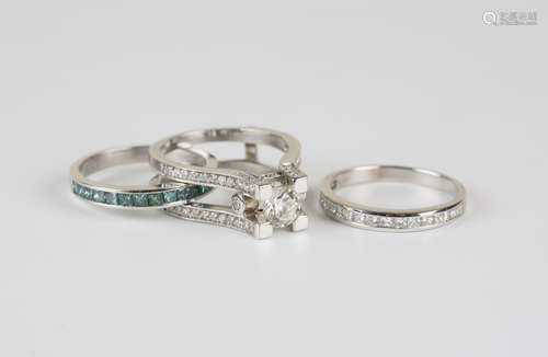 A white gold and diamond set combination three part ring, the principal ring mounted with a circular