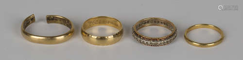 An 18ct gold decorated wedding ring, London 1971, an 18ct gold wedding ring (cut and bent), a 22ct