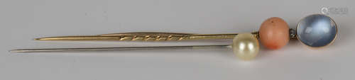 A gold and moonstone stickpin, a gold, coral and diamond stickpin and an imitation pearl stickpin,