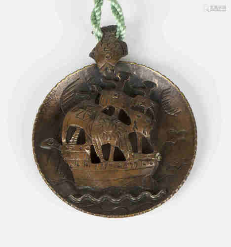 A copper disc shaped pendant in an Arts & Crafts inspired design of a three masted sailing galleon