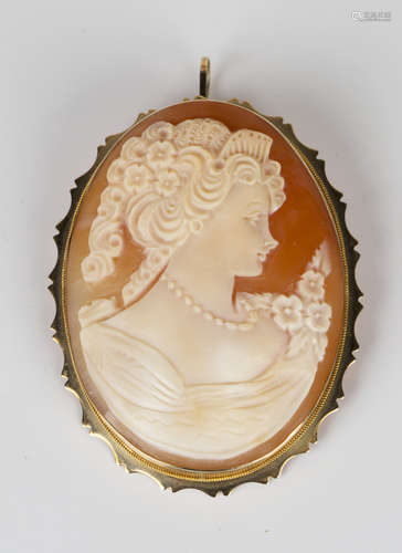 A gold mounted oval shell cameo pendant brooch, carved as a portrait of a lady with flowers,