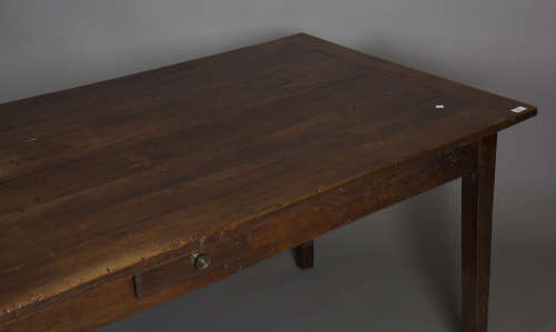 A 19th century fruitwood farmhouse table, the rectangular top above a central frieze drawer,