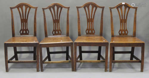 A harlequin set of ten George III provincial elm pierced splat back
dining chairs, all with solid