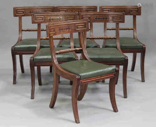A set of six Regency mahogany bar back dining chairs, the backs with ebony inlaid floral sprays