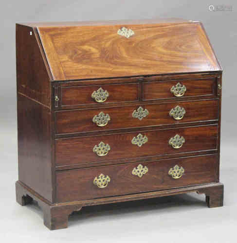 A George III mahogany bureau, the fall front revealing a fitted interior above two short and three