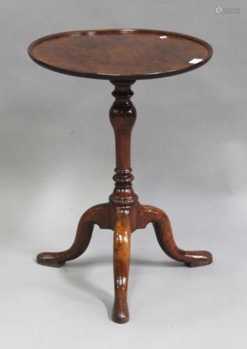 A George I and later mahogany and walnut circular wine table, on a turned baluster stem and tripod