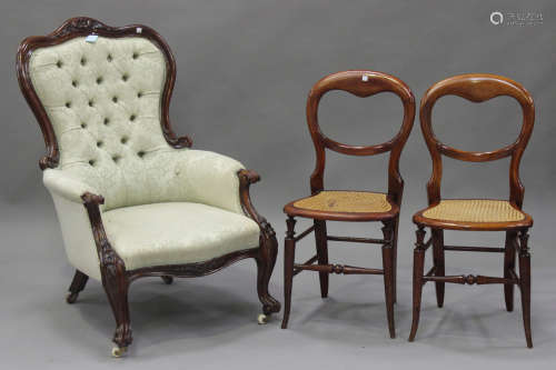 A Victorian walnut gentleman's salon armchair, carved with flower and leaf decoration, upholstered