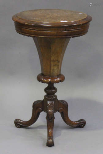 A Victorian burr walnut circular work table, the hinged top revealing a compartmentalized