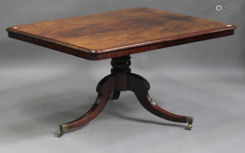A George III mahogany rectangular single pedestal dining table, the tripod cabriole legs carved with