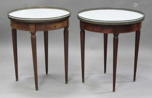 A near pair of French mahogany circular occasional tables, each inset with a white marble top