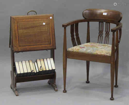 An Edwardian mahogany tub back armchair with inlaid decoration, the upholstered seat raised on