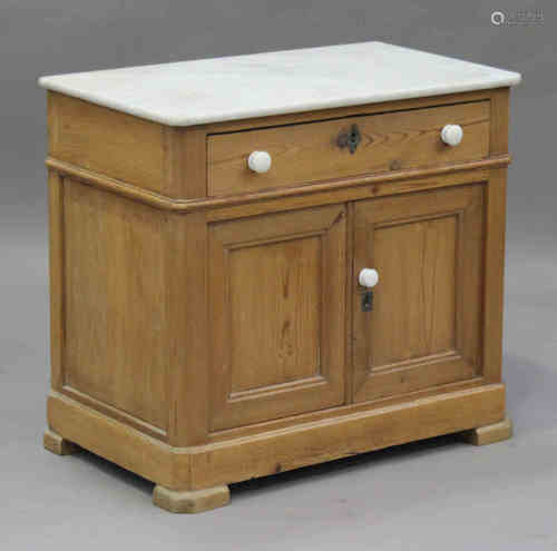 A late 19th century stripped pine washstand with marble top, fitted with a drawer and a pair of