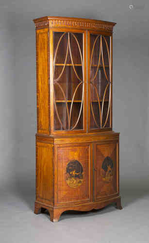 An Edwardian satinwood bowfront bookcase cabinet with overall ebony line inlaid and crossbanded