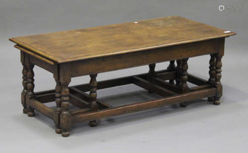 A 20th century nest of three oak occasional tables, raised on turned and block legs, height 43cm,