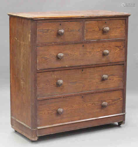 A late Victorian pitch pine chest of two short and three long drawers, on a plinth base and castors,