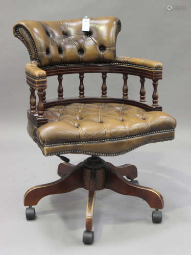 A 20th century reproduction buttoned brown leather tub back office chair, on downswept legs and