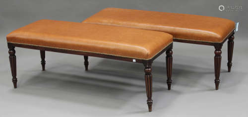 A pair of late 20th century Regency style mahogany footstools with overstuffed brown leather