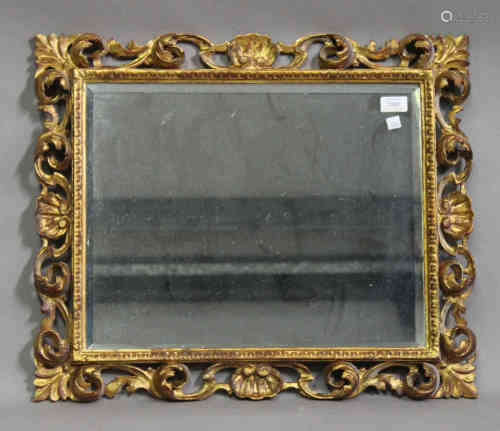 A late 19th century Florentine giltwood rectangular wall mirror with shell and scroll decoration,