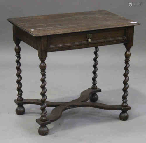 An early 18th century oak side table, the frieze fitted with a drawer, raised on barley twist legs