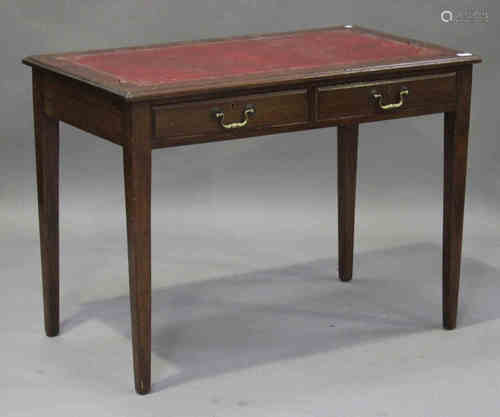 An early 20th century mahogany writing table, the gilt-tooled red leather top above two drawers,