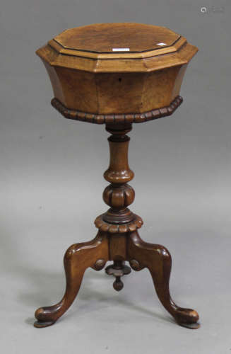 A Victorian burr walnut teapoy, the octagonal hinged top raised on a turned and baluster column